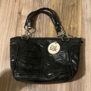 The Sak NWT black leather purse with silver